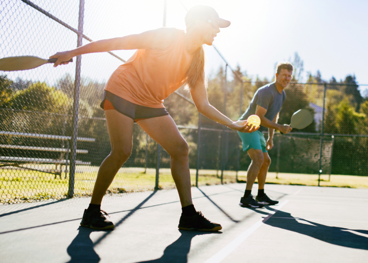 Couple playing pickleball together